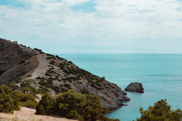 A scenic view of beach and coastal mountain