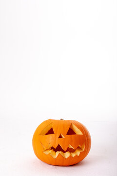 Composition of halloween jack o lantern and copy space on white background