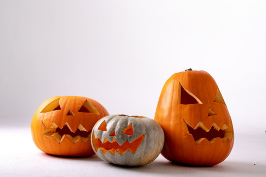Composition of halloween jack o lanterns and copy space on white background