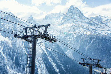Cable car mechanisms high in the snowy mountains. Activity and tourism. Close-up. Beautiful landscape.