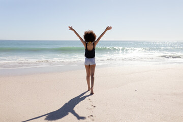 Fototapeta na wymiar Mixed race woman standing on the beach