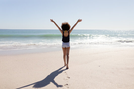 Mixed race woman standing on the beach