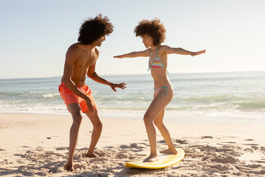 Young couple surfing on a beach