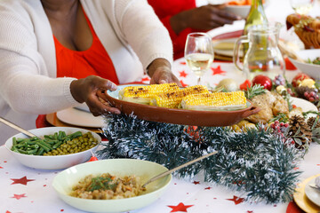 Senior african american woman with family in dining room