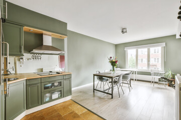 Contemporary minimalist style interior design of light studio apartment with wooden table and...