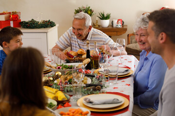 Multi generation caucasian family sitting at table