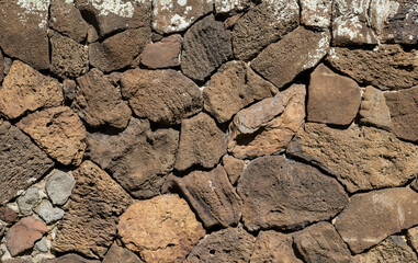 Ancient Hawaiian Brown Lava Wall with White Lichen.
