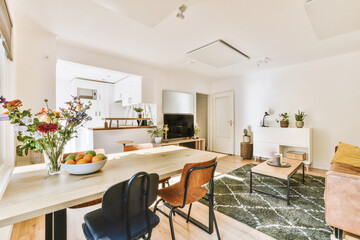 Contemporary minimalist style interior design of light studio apartment with wooden table and...