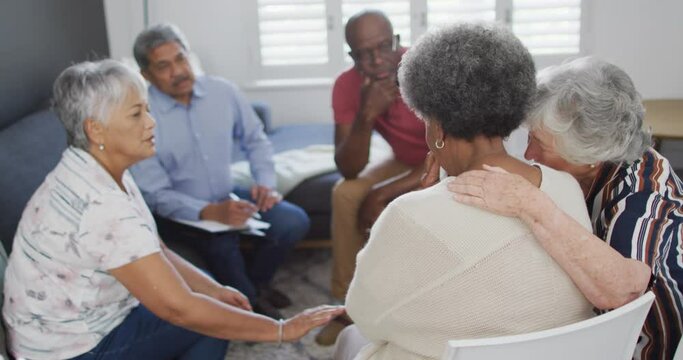 Diverse group of senior friends giving support to each other on meeting