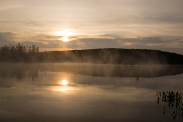 Fototapeta na wymiar Calm lake with mist rising