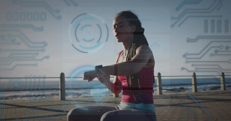 Round scanners and microprocessor connections against african american fit woman using smartwatch - Powered by Adobe
