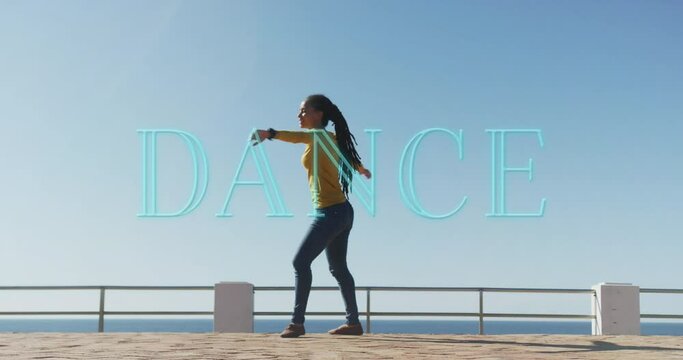 Neon dance text banner against african american woman dancing on the promenade