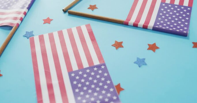American flags with red and blue stars lying on blue background