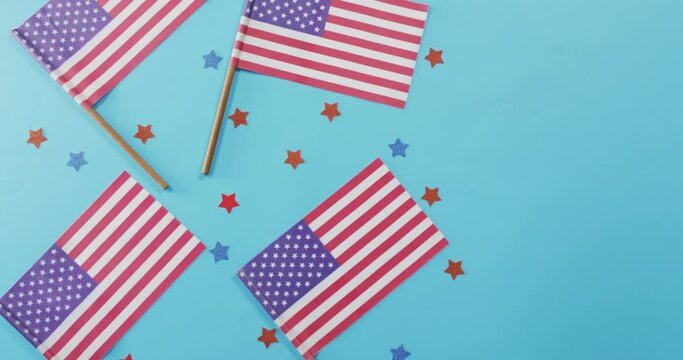 American flags with red and blue stars lying on blue background