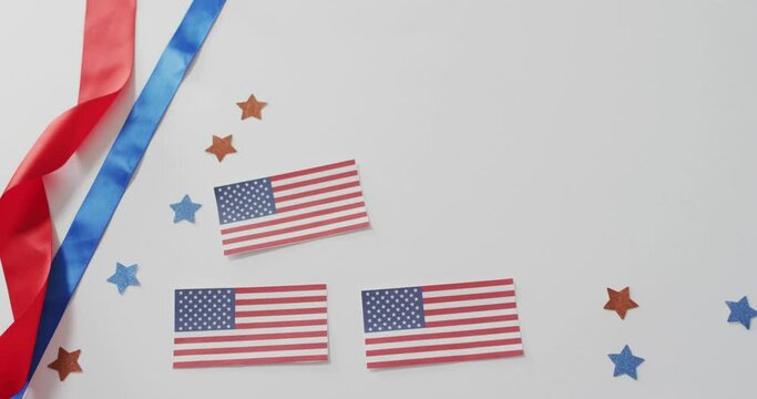 American flags with red and blue stars lying on white background