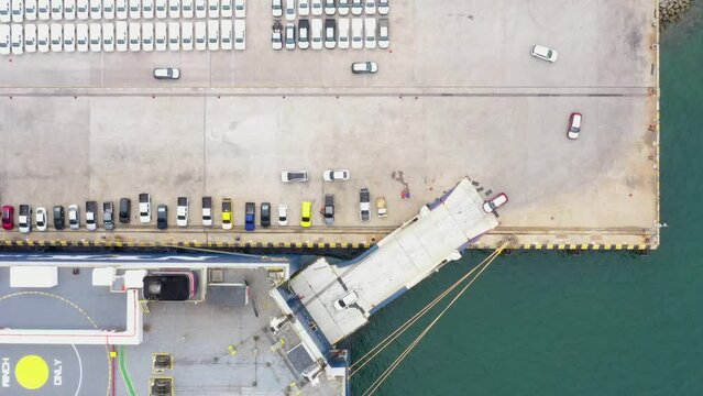 Aerial top view a lot of new car for export import by Roll-on Roll-of ship large at car factory depot for delivery new car to customer and dealer international and worldwide. 4k video from drone.