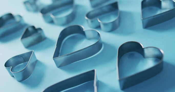 Heart shape cookie cutters on blue background at valentine's day