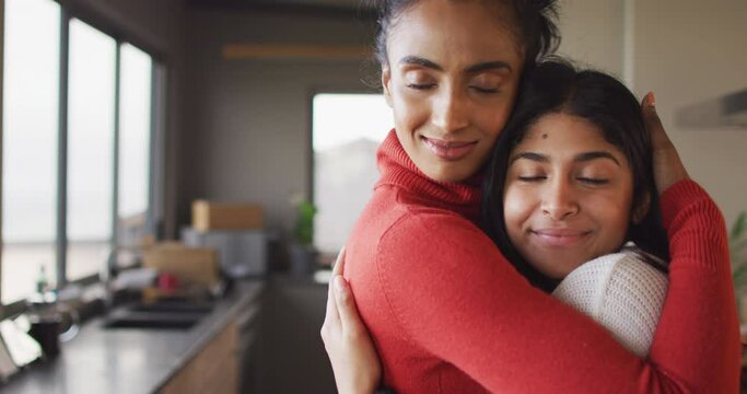 Video of happy biracial female friends embracing