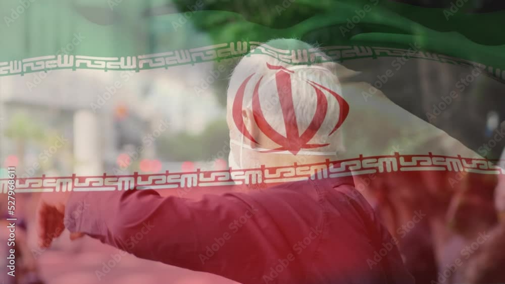 Wall mural Animation of flag of iran waving over caucasian man wearing face mask in city street