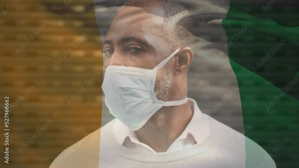 Sticker Animation of flag of ivory coast waving over african american man wearing face mask in city street