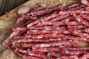 thin dried meat sausages with spices , close up