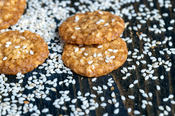 oatmeal thin round cookies with lots of sesame seeds