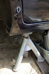 Car rapair safety. Using a tripod support when working on a jack