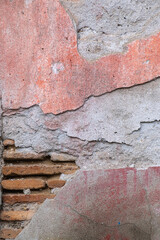 concrete plaster is worn out. old brick wall.