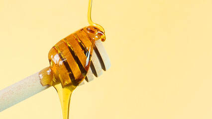 Honey being poured on a dipper. Health and beauty product sustainable lifestyle concept. Close up...