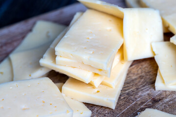 cut into pieces real hard cheese with lots of milk