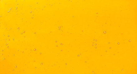 Golden liquid with bubbles full screen abstract wallpaper background.