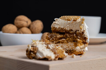 a piece of cake with buttercream and walnuts