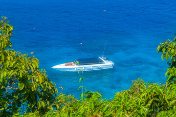 Close up on the boat in the middle of turquoise blue waters of Andaman sea next to Similan islands, Phuket, Thailand, horizontal image with copy space for text