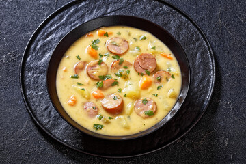 German potato soup with sausages in bowl