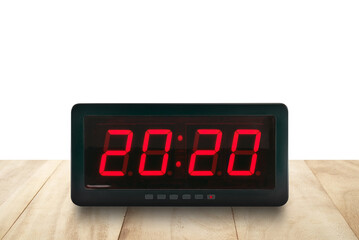 red led light illuminated numbers 2020 on digital electric alarm clock face on brown wooden table top isolated on white background, twenty o'clock twenty minutes, time to go to bed