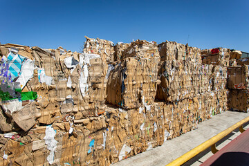 Bales of trash and cardboard at a dump