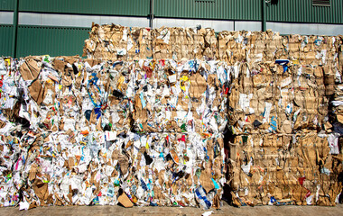 Bales of trash and cardboard at a dump
