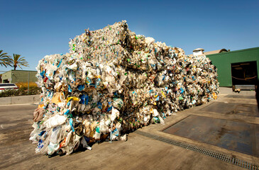 Bales of trash and cardboard at a dump