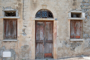 Fototapeta na wymiar Facade of a house with an old door in Lumio Corsica France