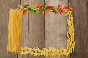 Raw spaghetti and pastas arranged on wooden table