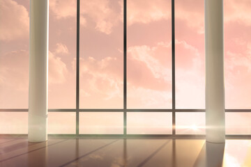 Room with large windows showing sunrise