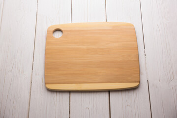 Chopping board on textured wooden flooring