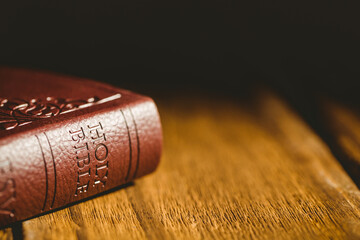 Brown bible on table