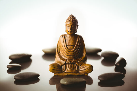Buddha figurine surrounded by pebbles 