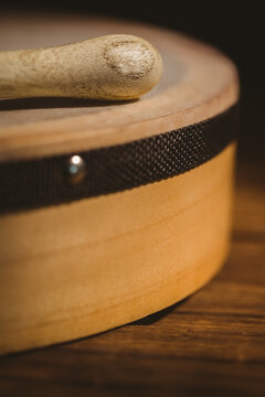 Close-up of wooden bodhran with stick