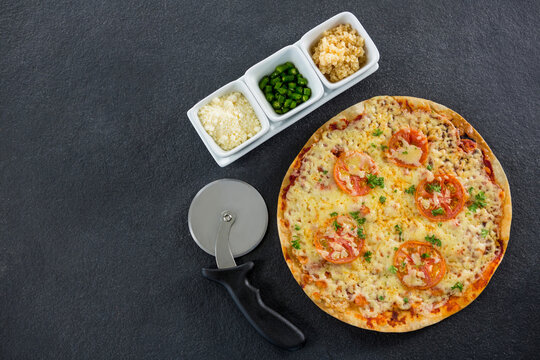 Fresh Pizza By Cutter And Spices On Stone Tray