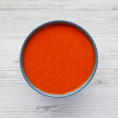 Homemade Tomato Soup on a white wooden background, top view. Flat lay, overhead, from above.