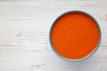 Homemade Tomato Soup on a white wooden background, top view. Flat lay, overhead, from above. Copy space.