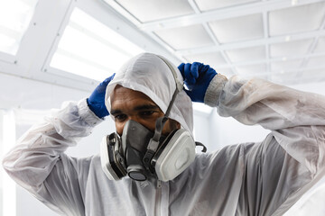 Portrait of a mixed race car painter setting mask
