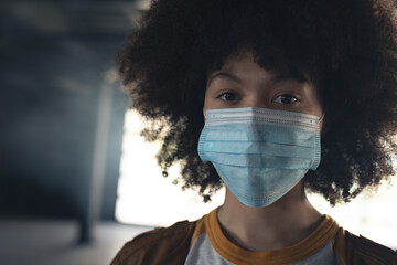 Portrait of mixed race woman wearing face mask looking to camera